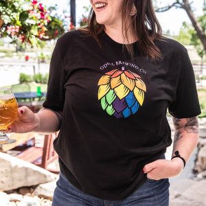 A person wearing a black shirt with a hop flower with rainbow colors